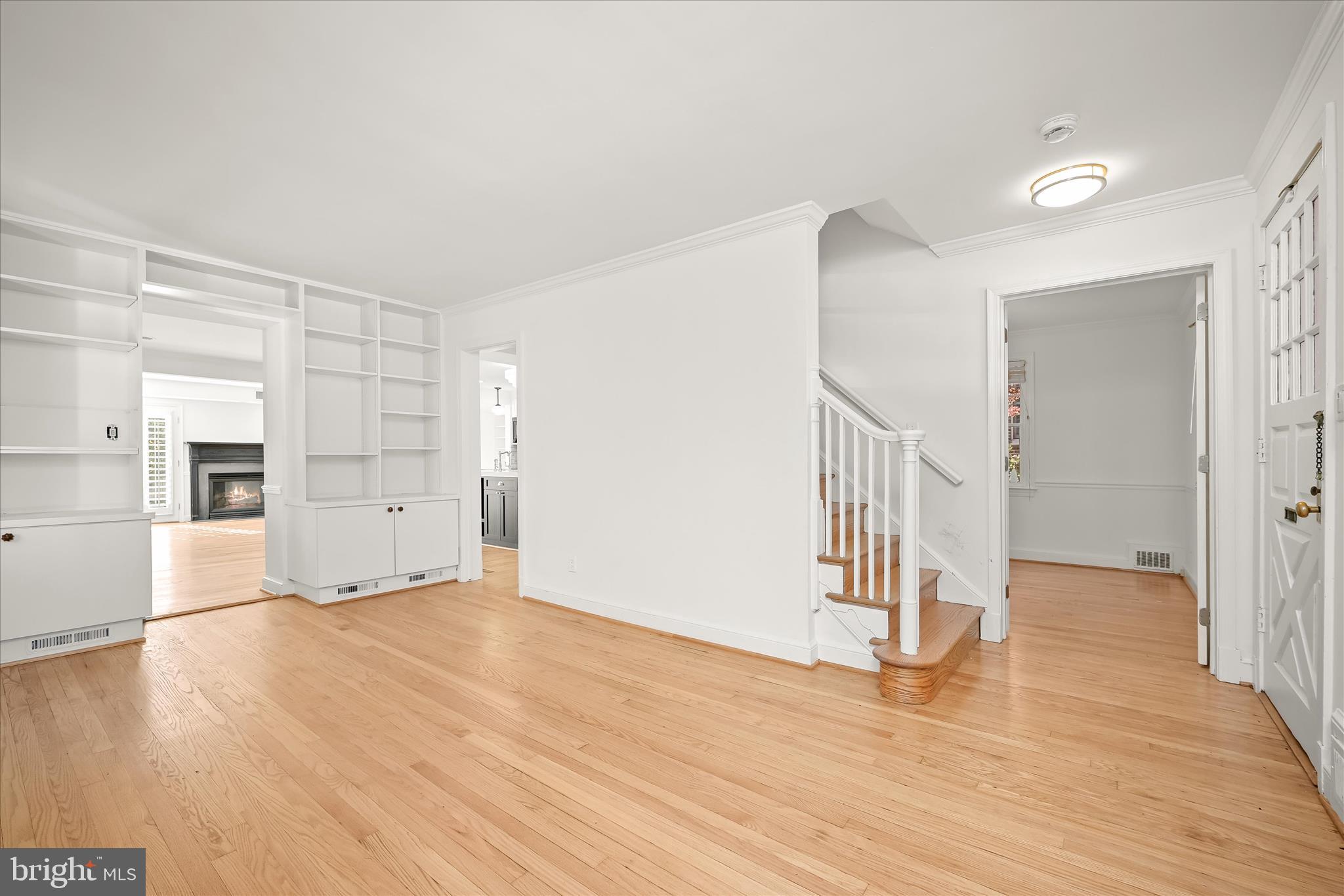 7012 Exeter Road Bethesda, MD 20814 - Photo 13 of 103 a view of empty room with wooden floor and kitchen