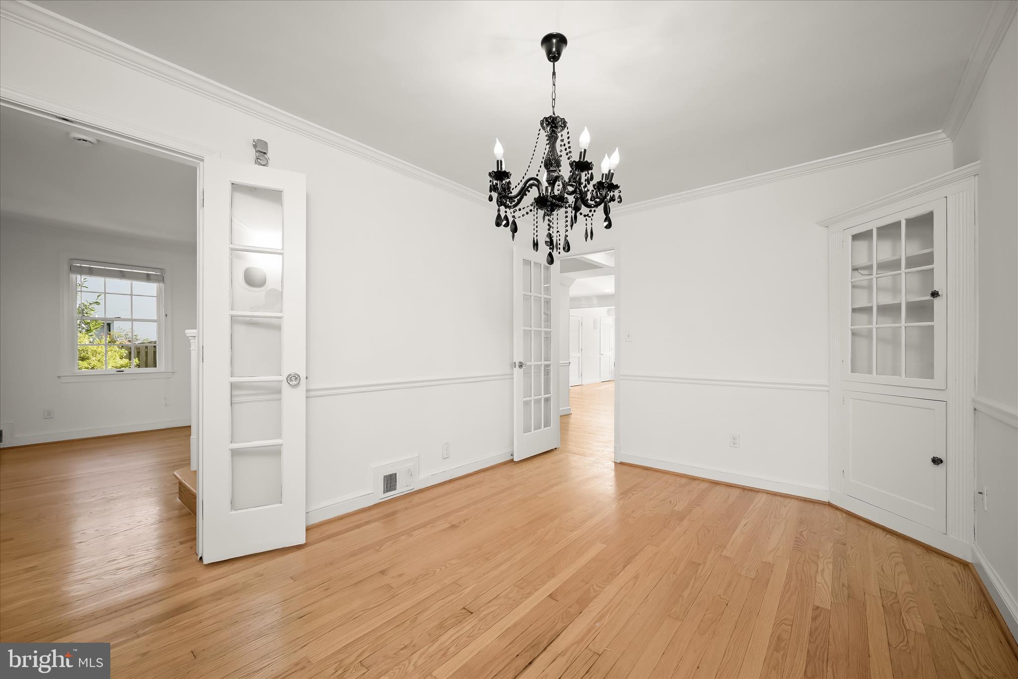 7012 Exeter Road Bethesda, MD 20814 - Photo 19 of 103 a view of a room with wooden floor and a chandelier