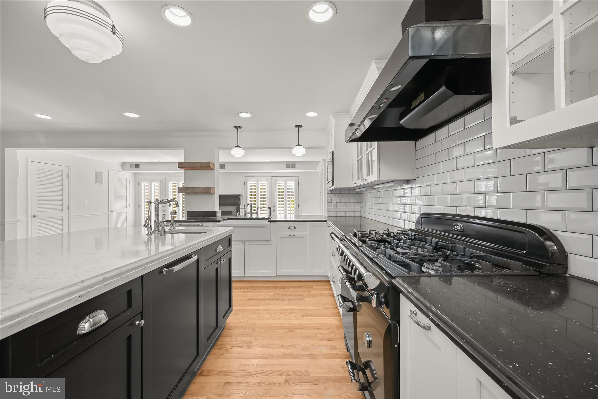 7012 Exeter Road Bethesda, MD 20814 - Photo 26 of 103 a kitchen with stainless steel appliances granite countertop a sink a stove and a wooden floors