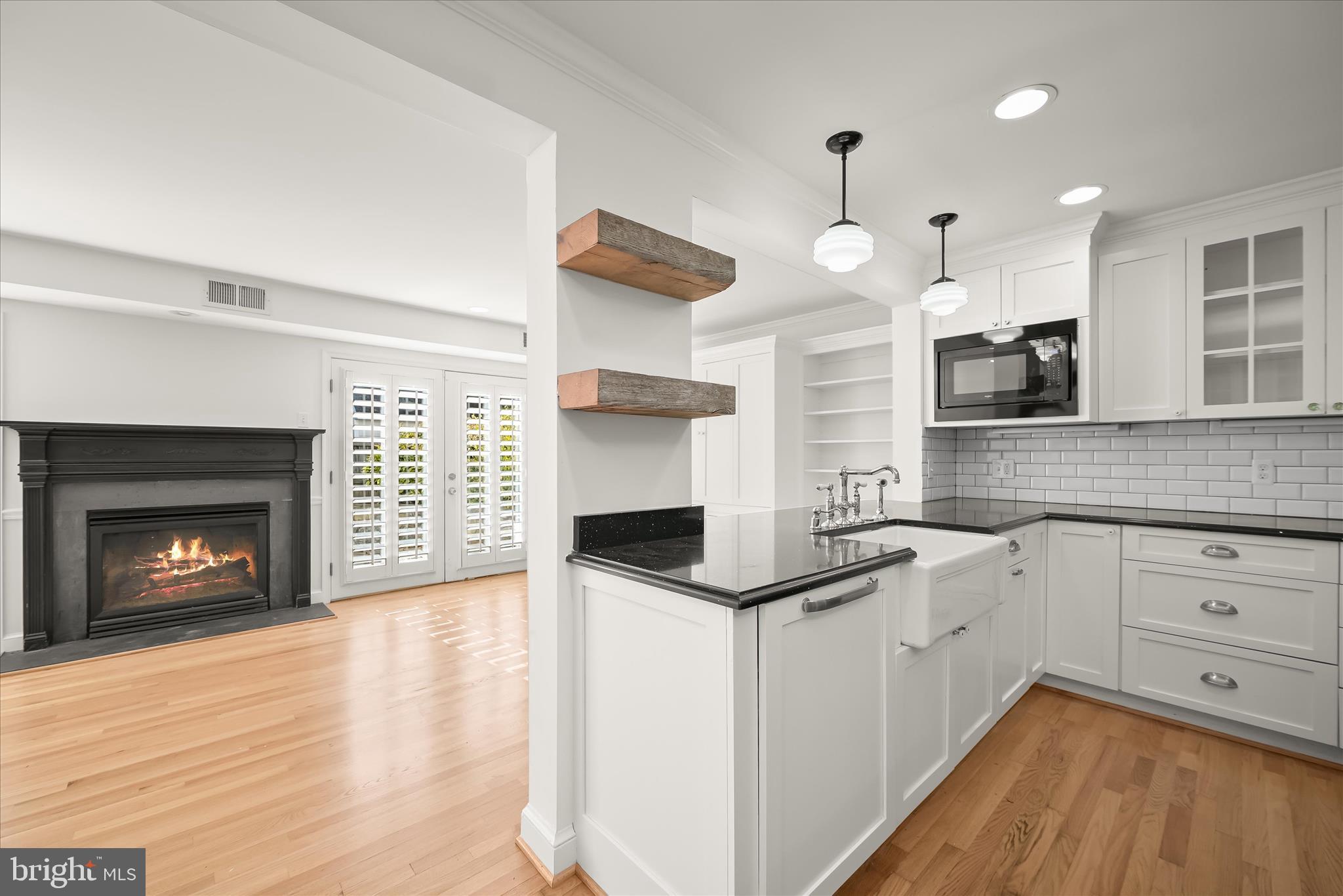 7012 Exeter Road Bethesda, MD 20814 - Photo 35 of 103 a kitchen with stainless steel appliances granite countertop a stove a sink and white cabinets with wooden floor