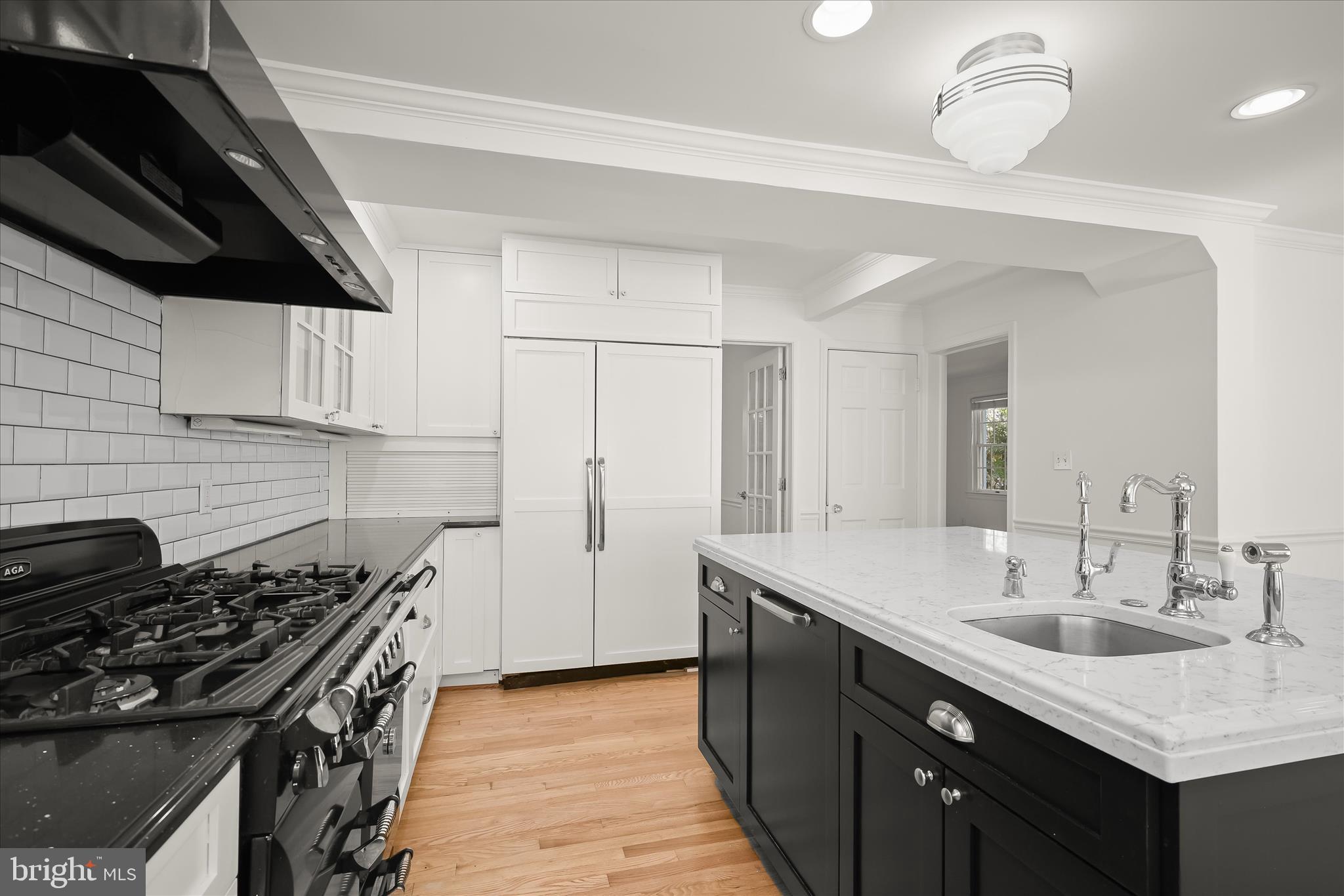 7012 Exeter Road Bethesda, MD 20814 - Photo 37 of 103 a kitchen with a sink a stove and cabinets