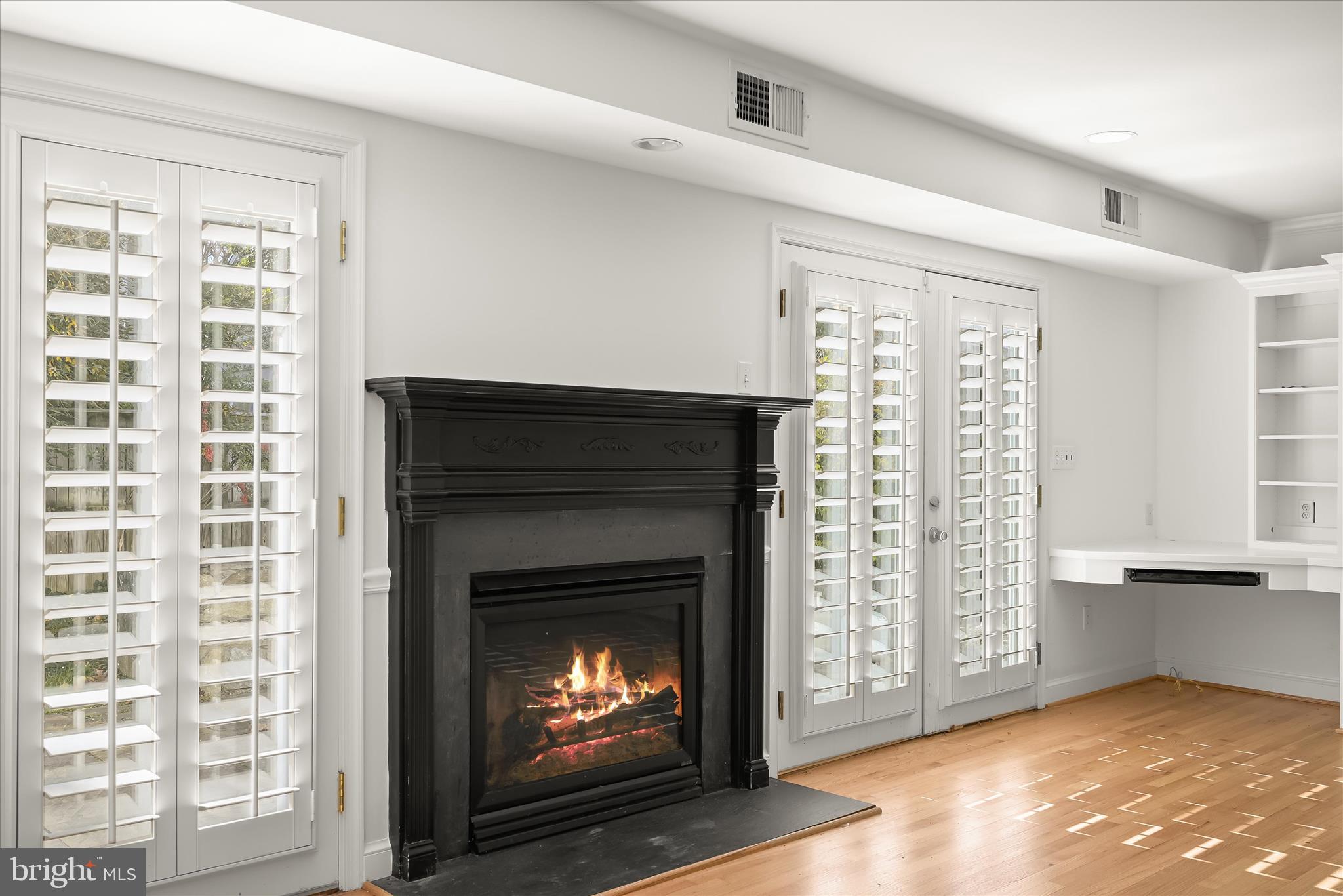 7012 Exeter Road Bethesda, MD 20814 - Photo 46 of 103 a living room with a fireplace and a window