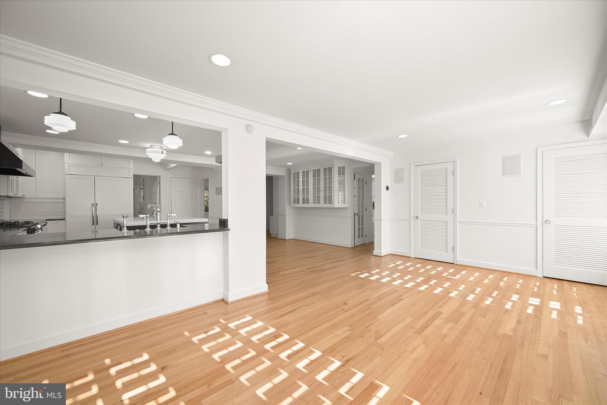 7012 Exeter Road Bethesda, MD 20814 - Photo 50 of 103 a view of a kitchen with kitchen island a sink wooden floor and a refrigerator