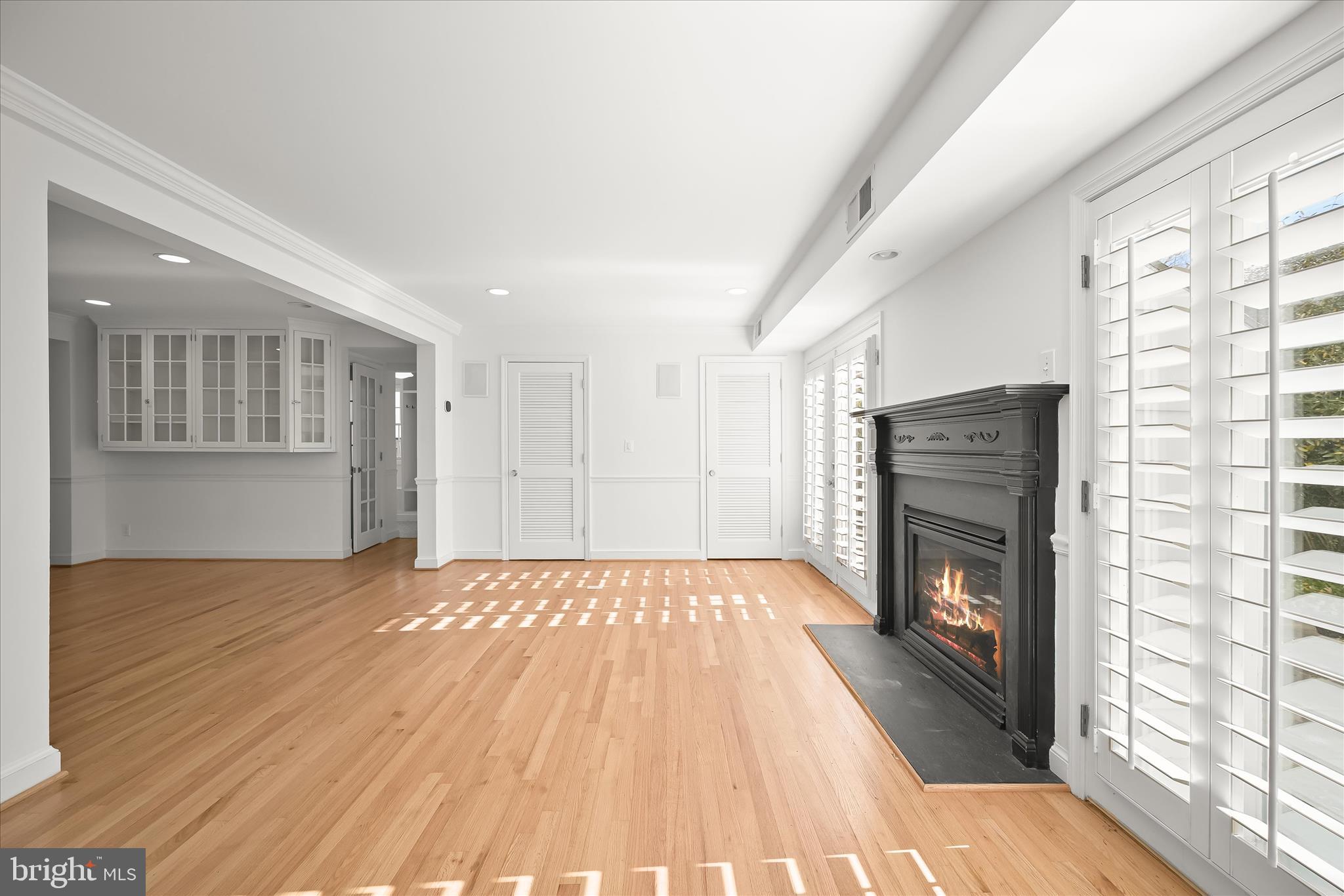 7012 Exeter Road Bethesda, MD 20814 - Photo 51 of 103 a view of empty room with wooden floor and fireplace