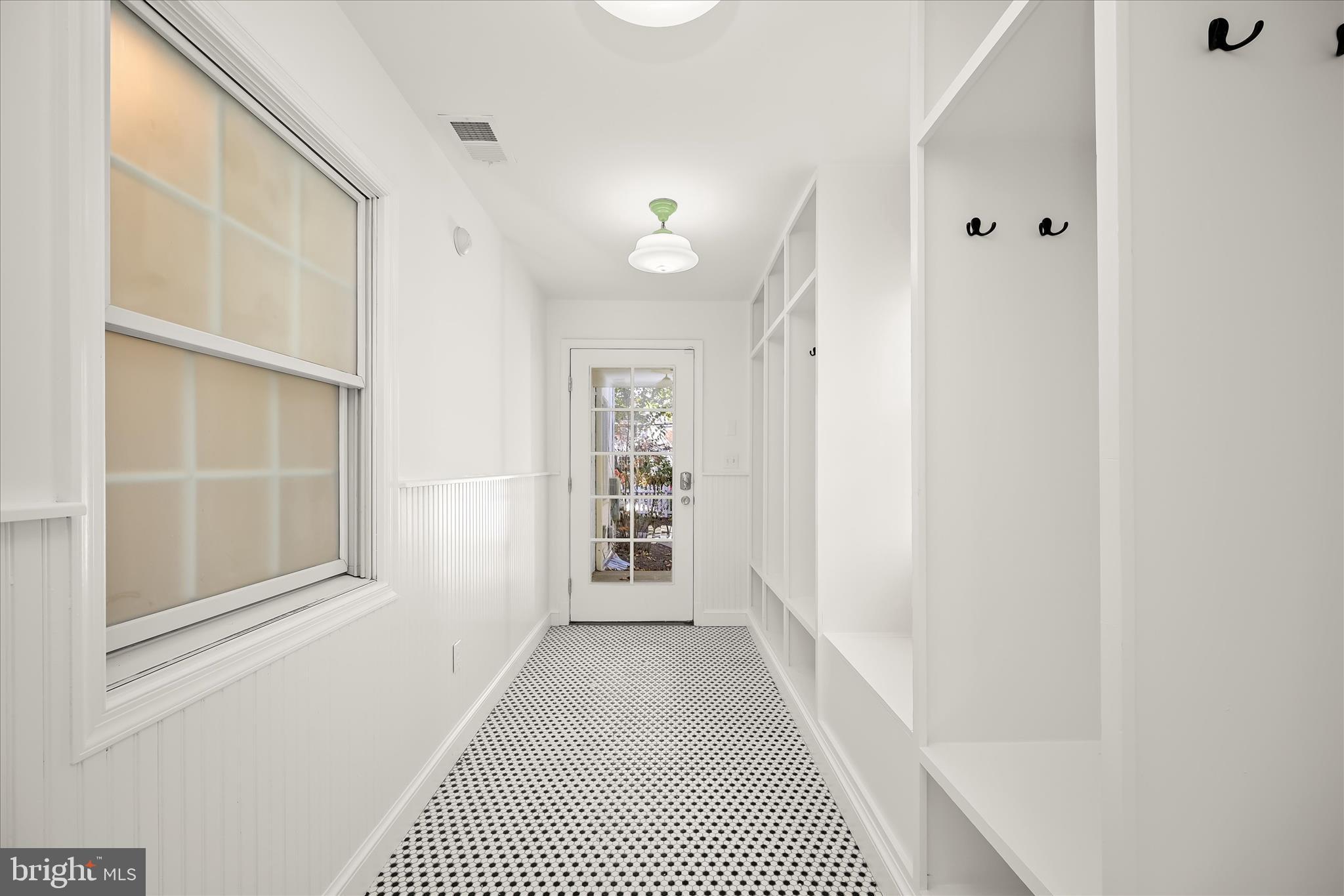7012 Exeter Road Bethesda, MD 20814 - Photo 56 of 103 a view of a hallway with wooden floor and a bathroom