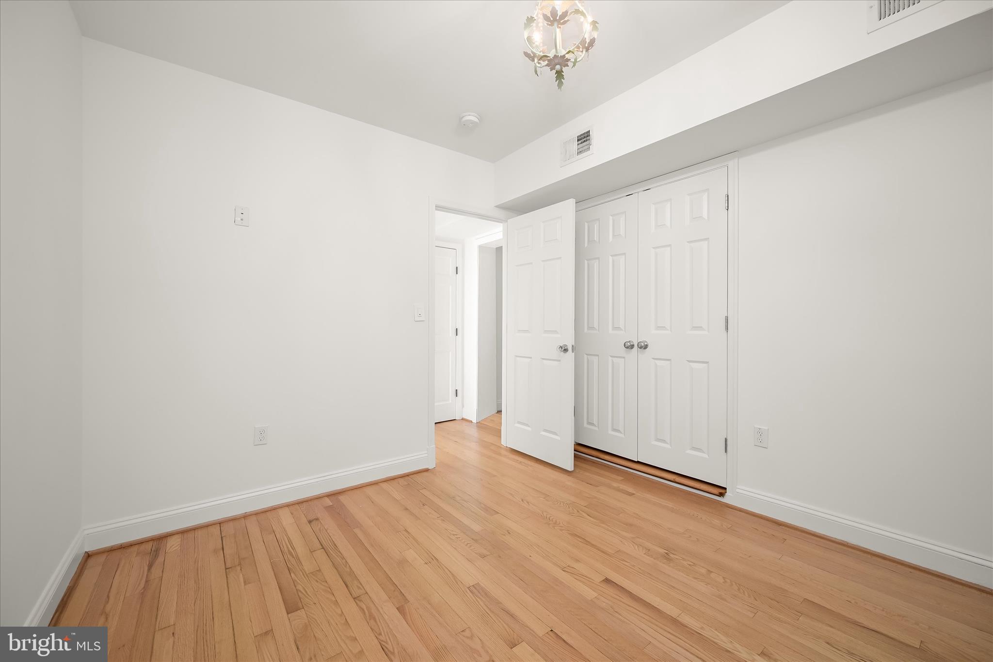 7012 Exeter Road Bethesda, MD 20814 - Photo 75 of 103 a view of an empty room with wooden floor
