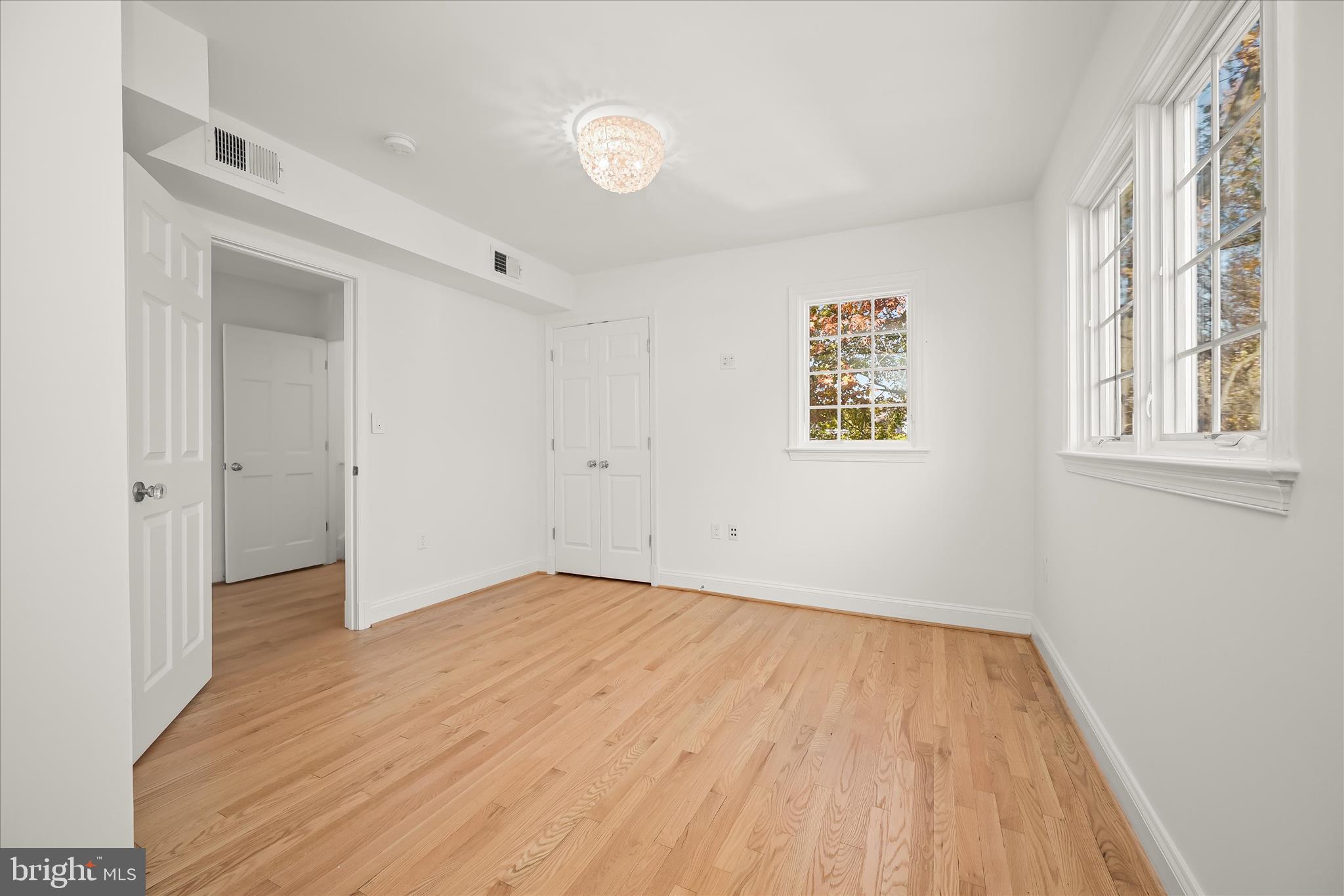 7012 Exeter Road Bethesda, MD 20814 - Photo 80 of 103 an empty room with wooden floor and windows