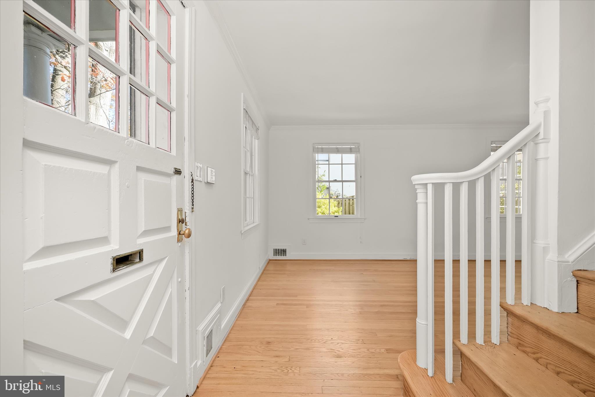 7012 Exeter Road Bethesda, MD 20814 - Photo 9 of 103 a view of an entryway with wooden floor and windows
