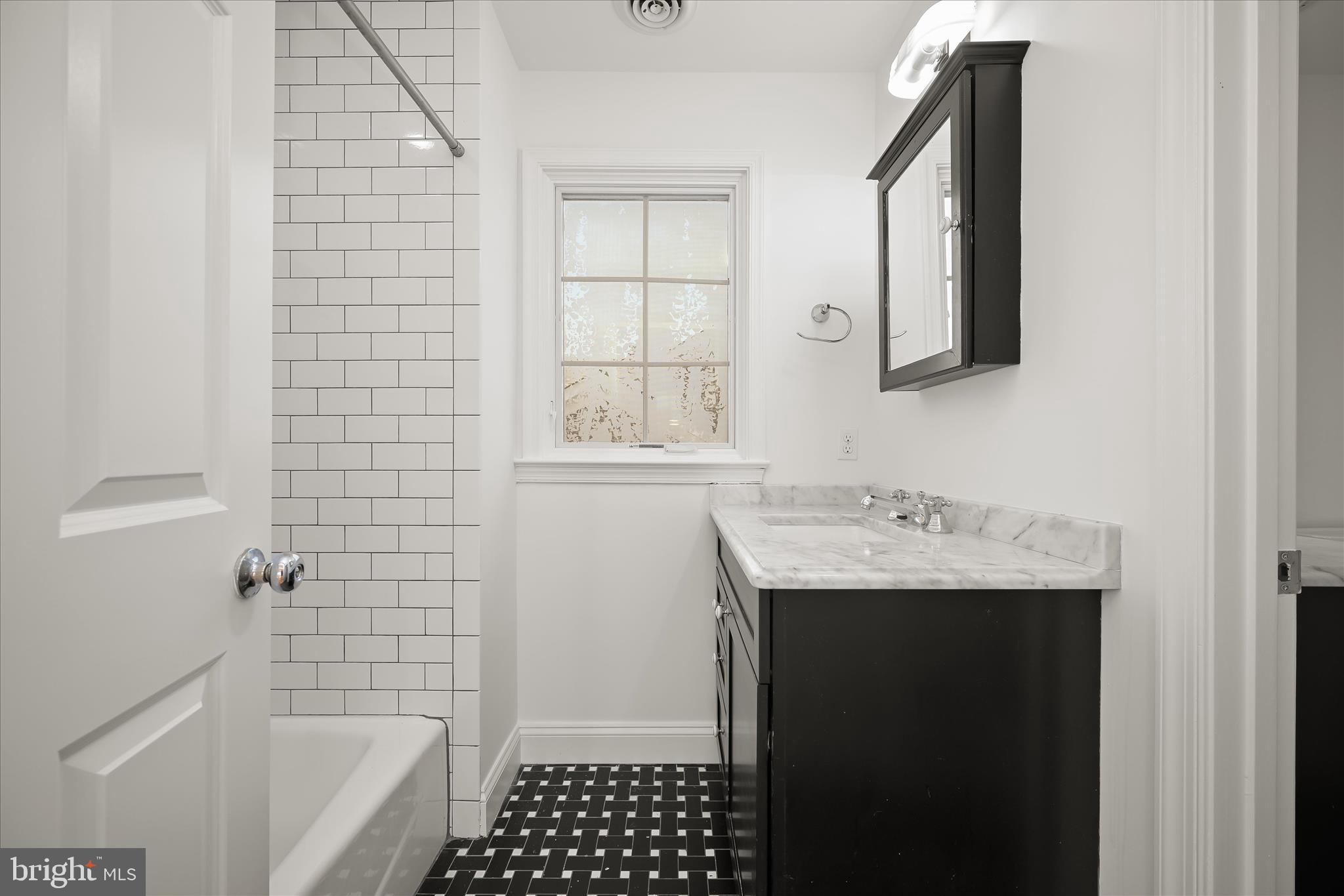 7012 Exeter Road Bethesda, MD 20814 - Photo 93 of 103 a bathroom with a sink a toilet and shower