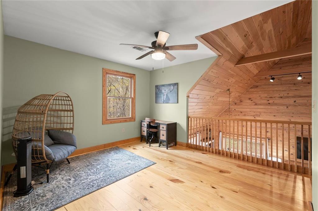 189 Frost Pine Circle Jasper, GA 30143 - Photo 21 of 42 a bedroom with a bed and wooden floor