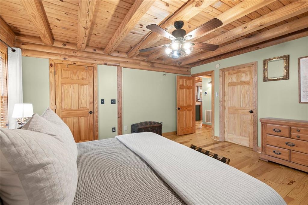 189 Frost Pine Circle Jasper, GA 30143 - Photo 22 of 42 a bedroom with a bed dresser and a chandelier