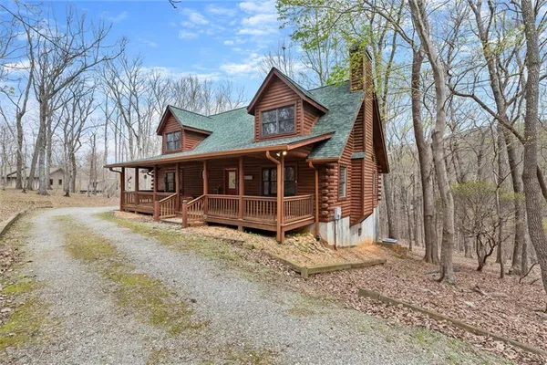 a view of a house with a yard and wooden fence