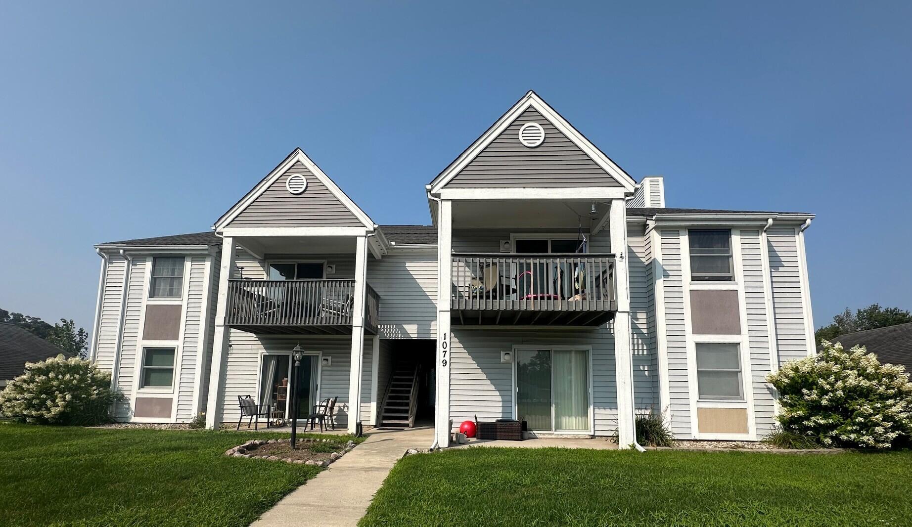 1079 Millpond Road, Unit A Valparaiso, IN 46385 - Photo 1 of 14 a front view of a house with a yard and porch