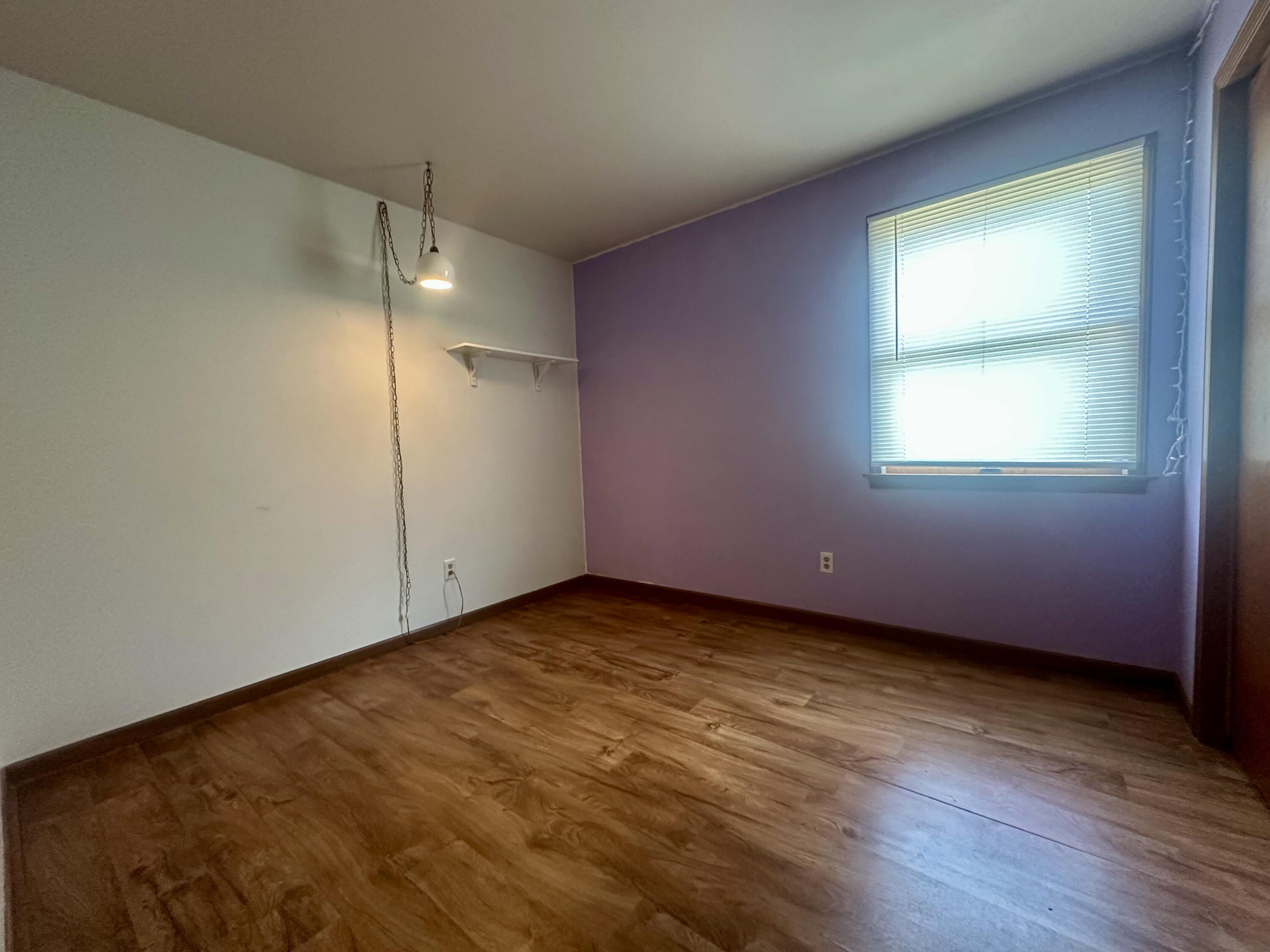 1079 Millpond Road, Unit A Valparaiso, IN 46385 - Photo 8 of 14 an empty room with wooden floor and windows