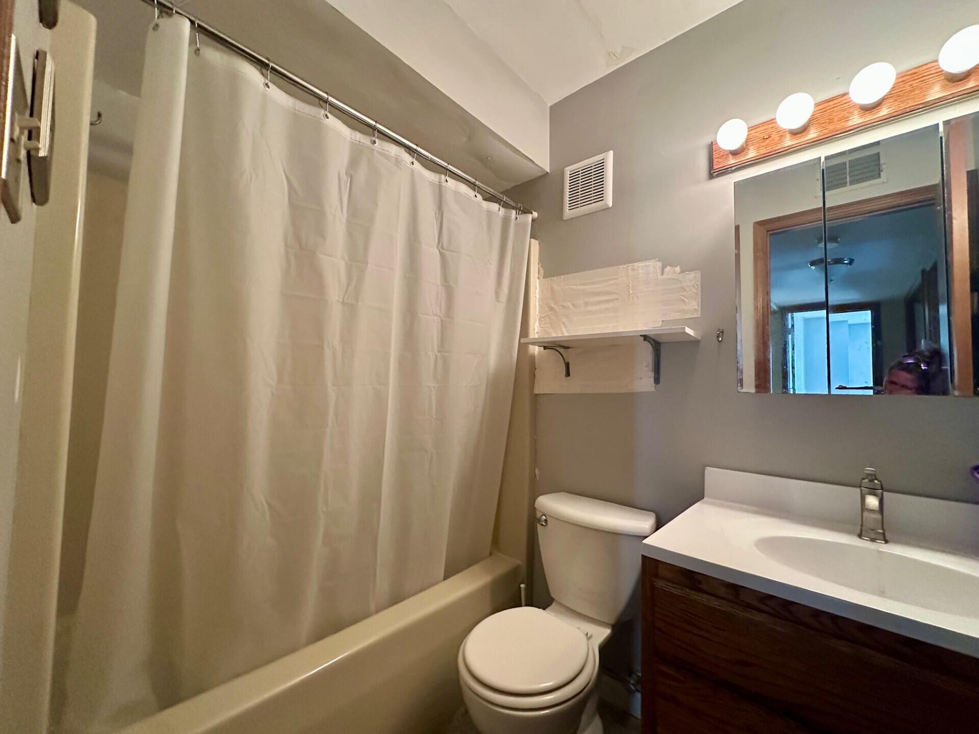 1079 Millpond Road, Unit A Valparaiso, IN 46385 - Photo 9 of 14 a white toilet sitting next to a bathroom sink