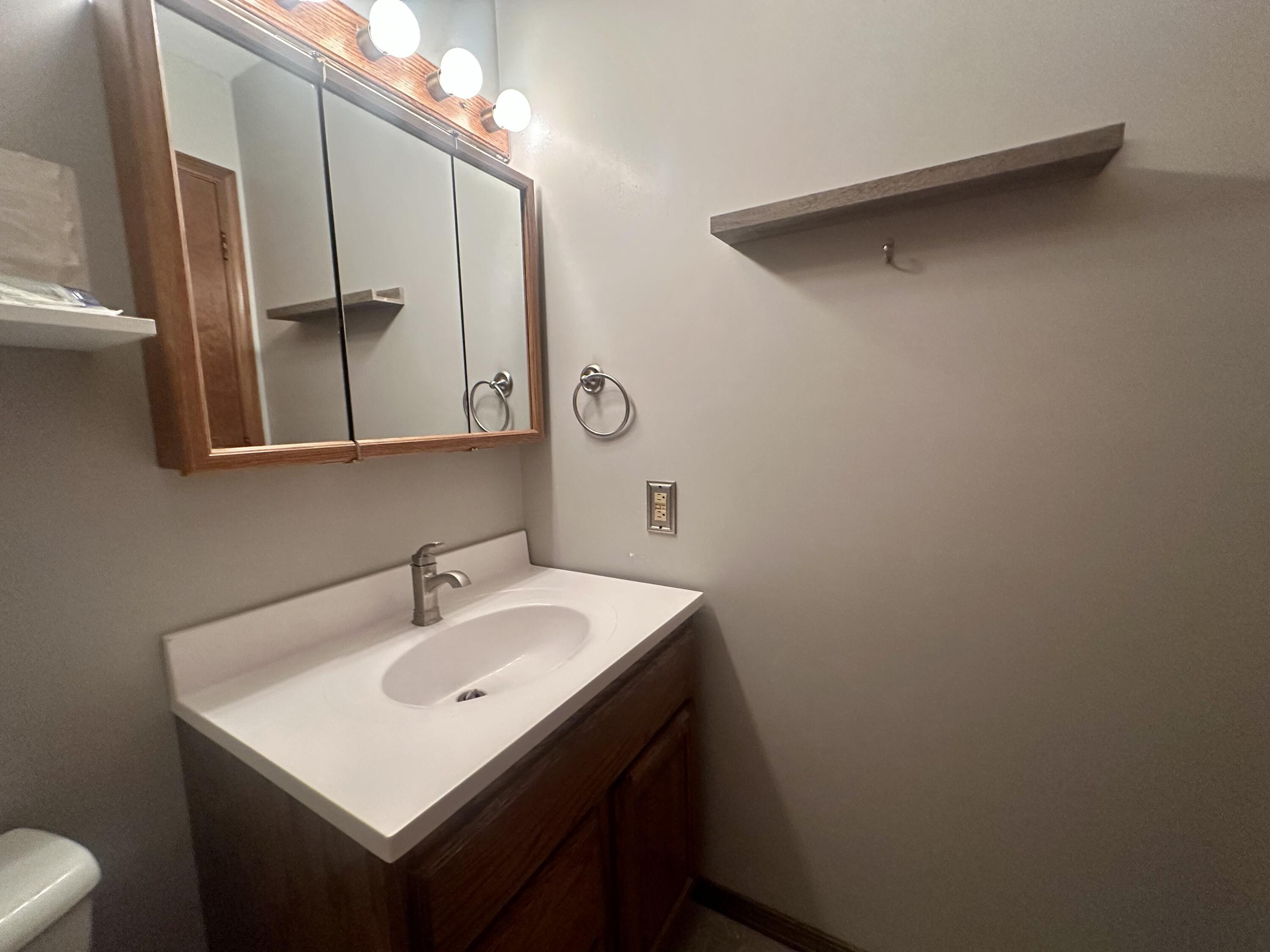 1079 Millpond Road, Unit A Valparaiso, IN 46385 - Photo 10 of 14 a bathroom with a sink and mirror