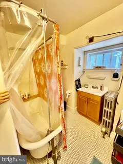 a bathroom with a tub sink and mirror