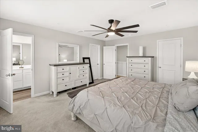 a bedroom with a bed and a dresser