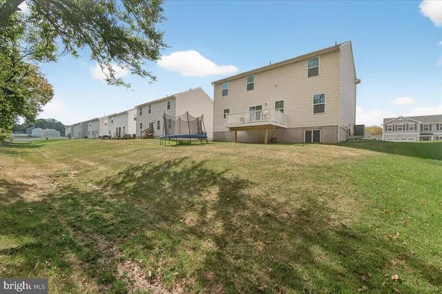 a view of a big yard with wooden fence