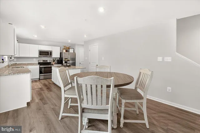 a view of a dining room with furniture and wooden floor