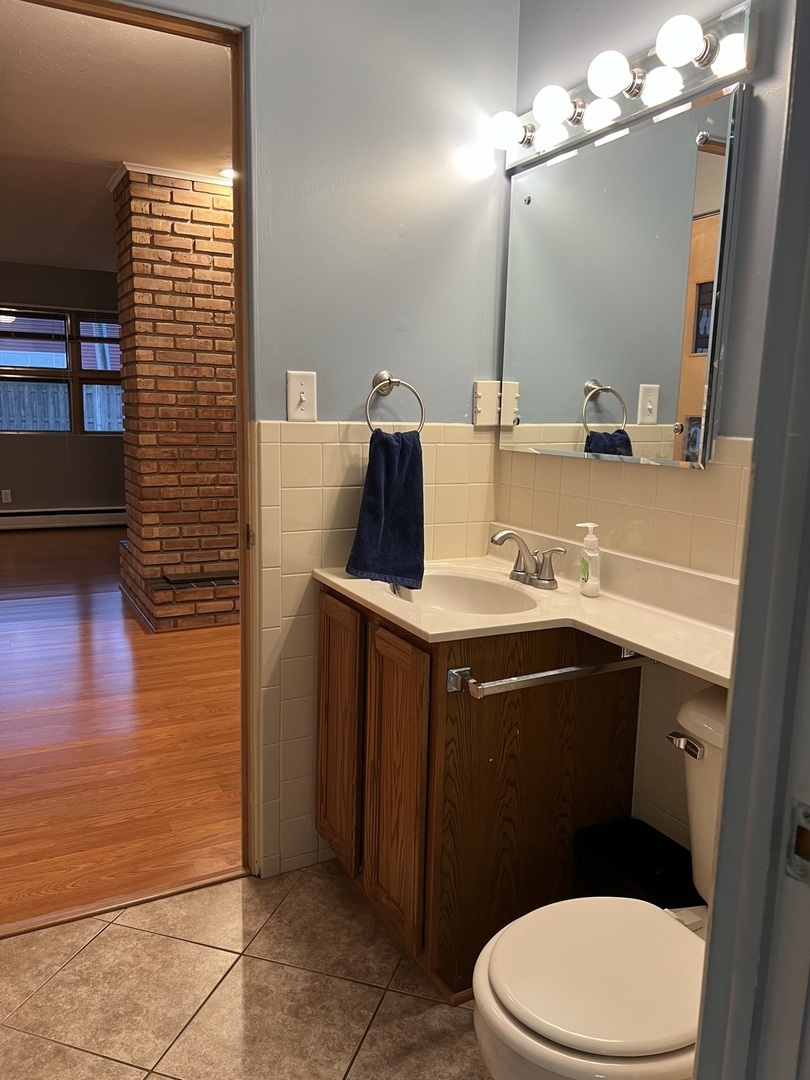1114 North Main Street Rochelle, IL 61068 - Photo 17 of 21 a bathroom with a sink vanity mirror and toilet