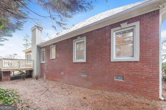 a brick building with a bench in front of it