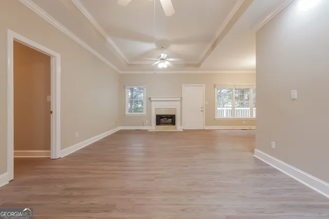 a view of an empty room with a fireplace and a window