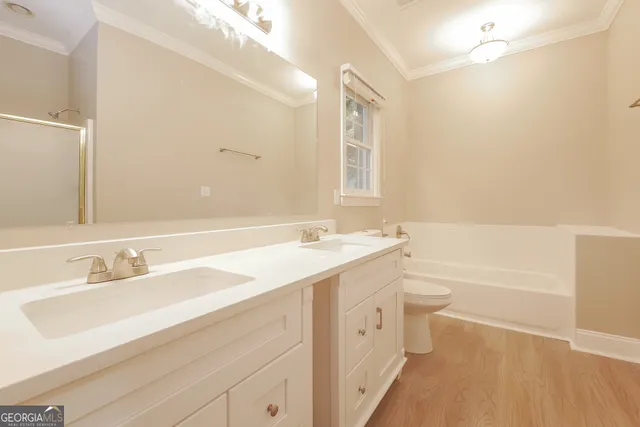 a bathroom with a sink a toilet a tub and a mirror