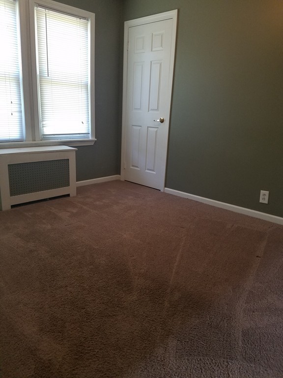 52 Stuart Street Springfield, MA 01109 - Photo 12 of 14 an empty room with a window
