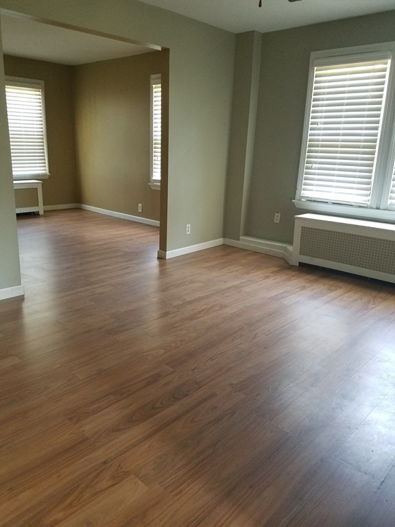 52 Stuart Street Springfield, MA 01109 - Photo 7 of 14 an empty room with wooden floor and windows