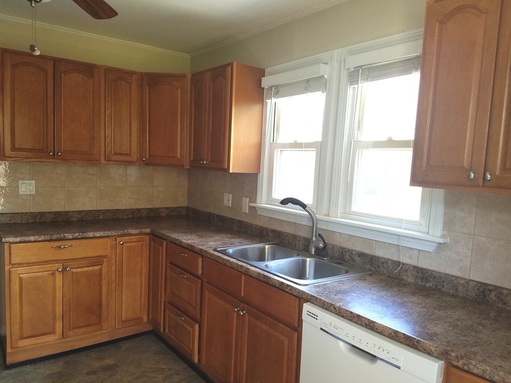 52 Stuart Street Springfield, MA 01109 - Photo 9 of 14 a kitchen with a sink cabinets and window