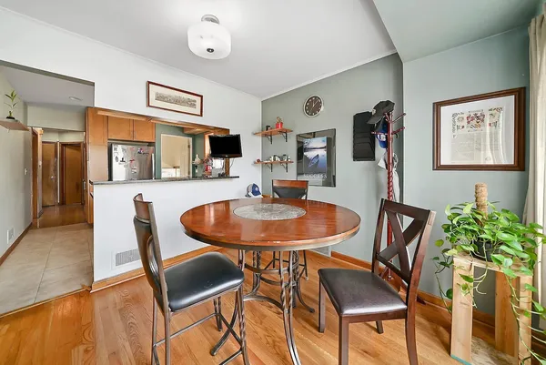 a dining room with furniture and wooden floor