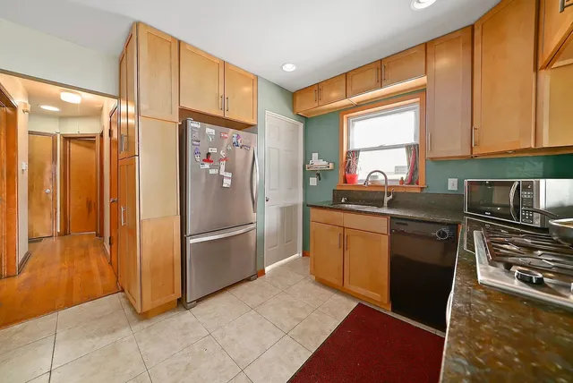 a kitchen with stainless steel appliances granite countertop a refrigerator sink and cabinets