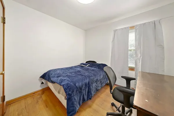 a bedroom with bed and a window