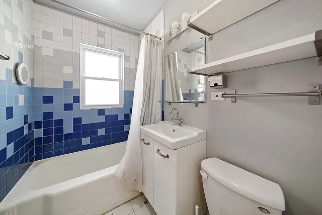 a bathroom with a sink a toilet and bathtub