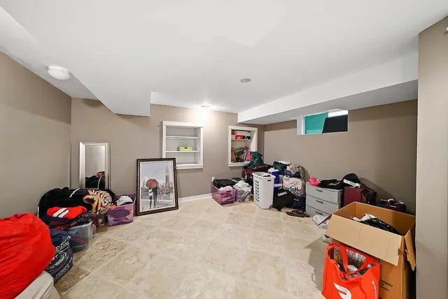 a bedroom with furniture and a book shelf