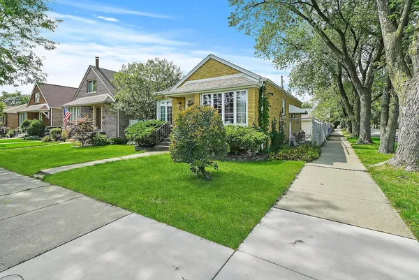 a front view of house with yard and green space
