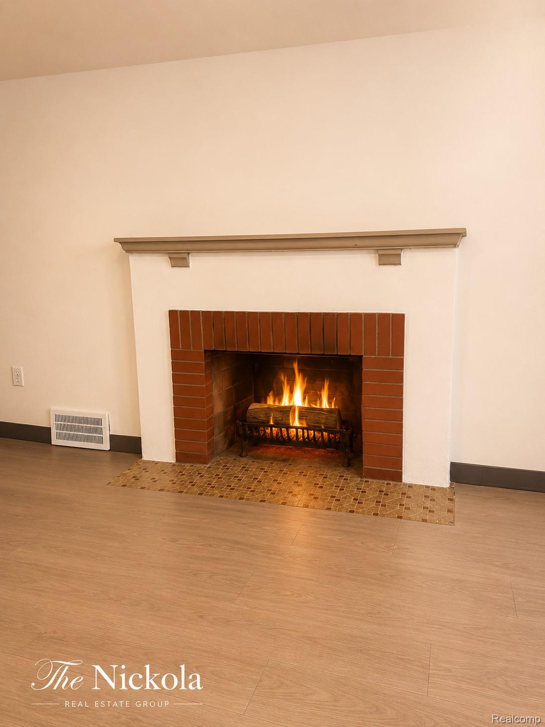 515 Barrington Road Detroit, MI 48215 - Photo 23 of 27 Detailed view of a brick fireplace and wood finished floors