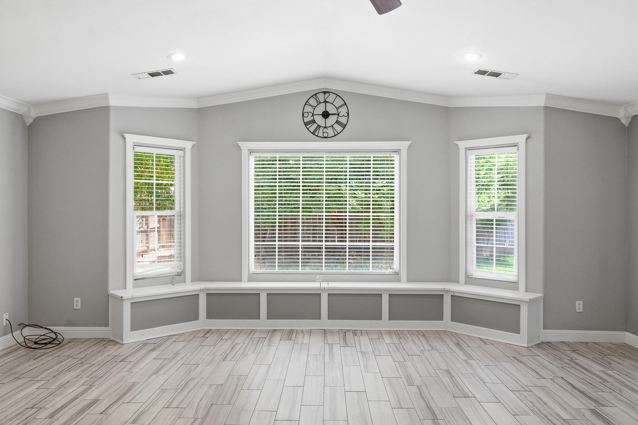 618 Birdsong Court Exeter, CA 93221 - Photo 19 of 62 an empty room with wooden floor and windows