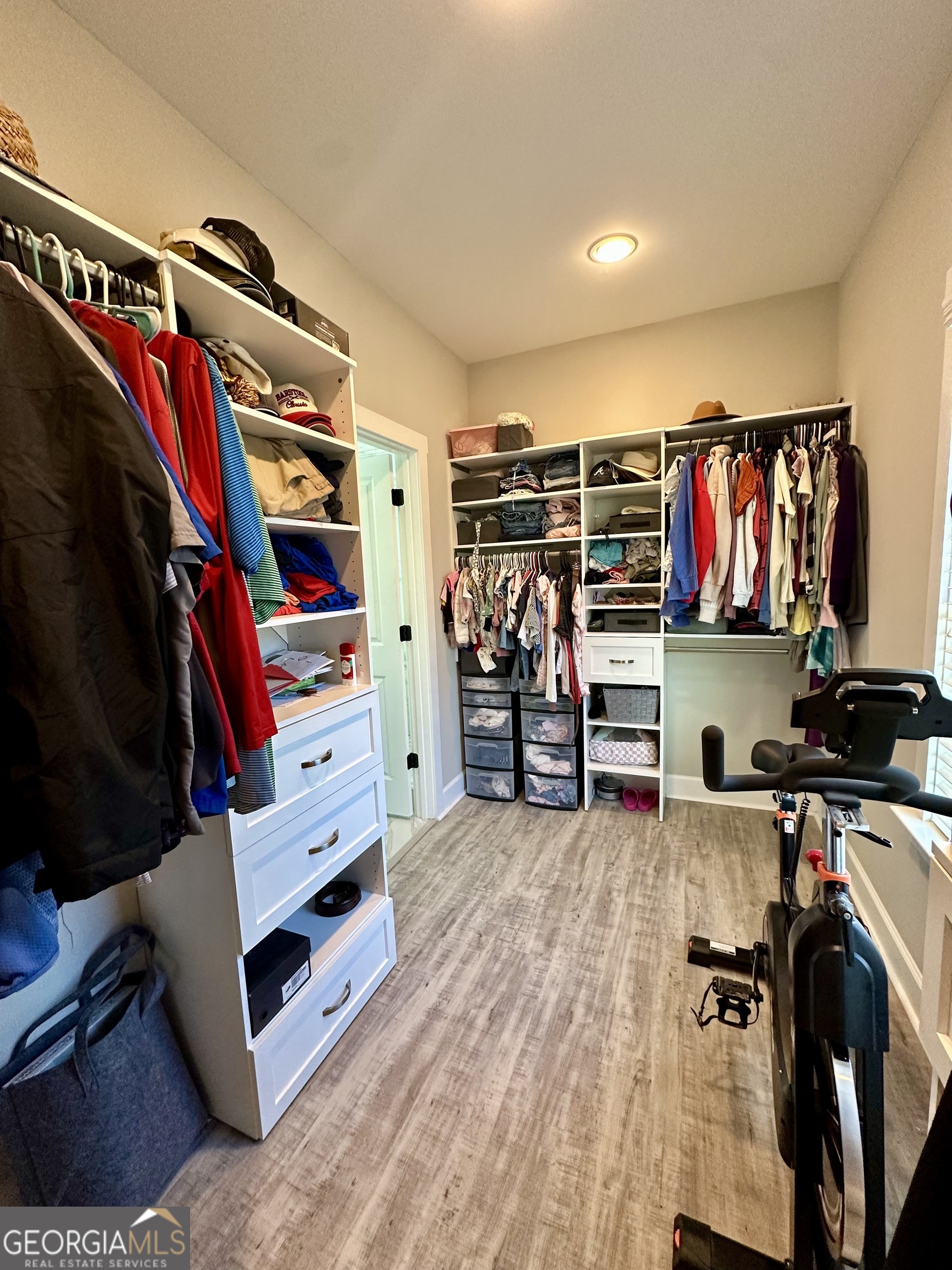 506 Summit View Drive Jefferson, GA 30549 - Photo 18 of 52 a view of walk in closet with clothes and shoes