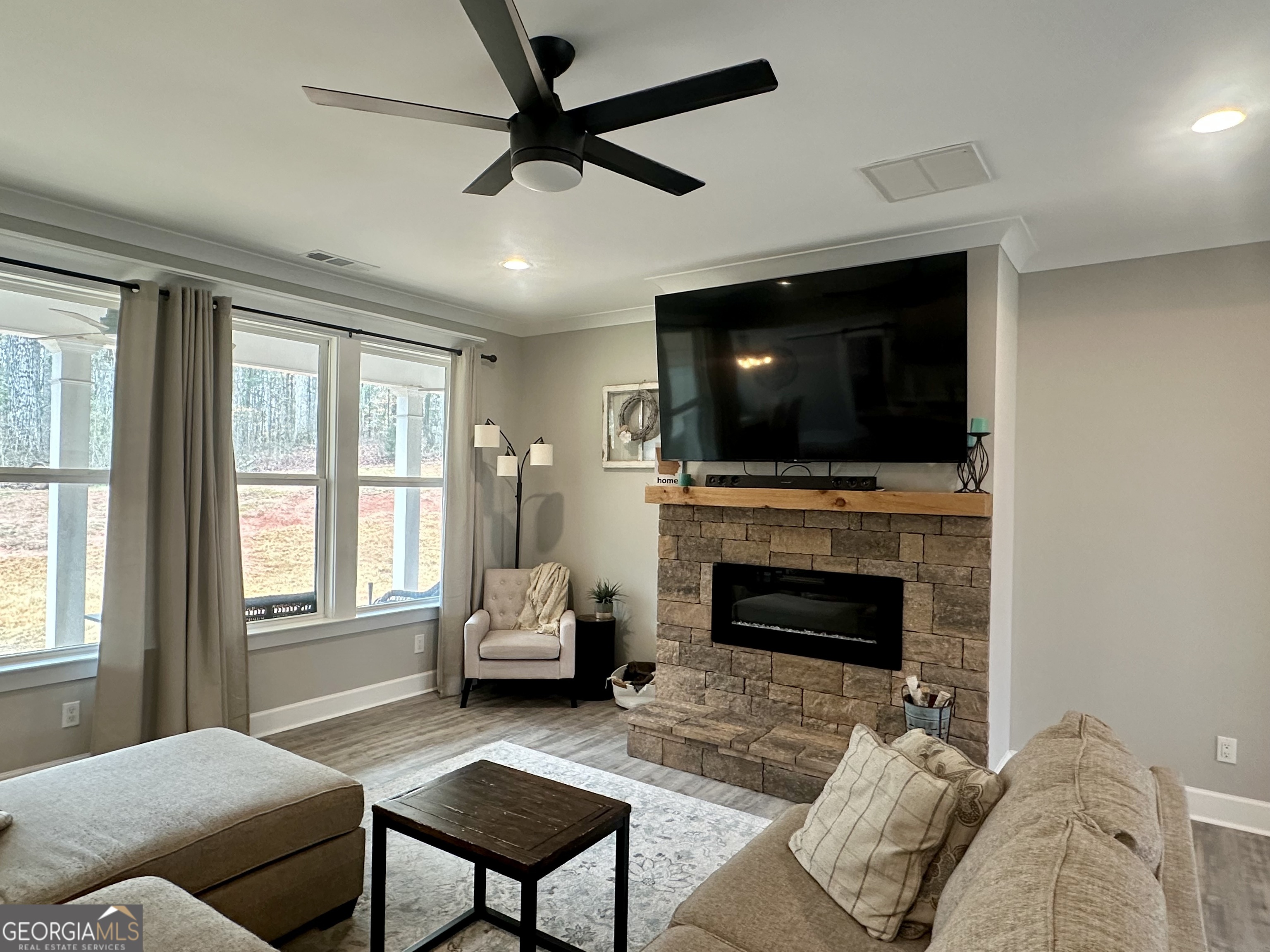 506 Summit View Drive Jefferson, GA 30549 - Photo 21 of 52 a living room with furniture a fireplace and a flat screen tv