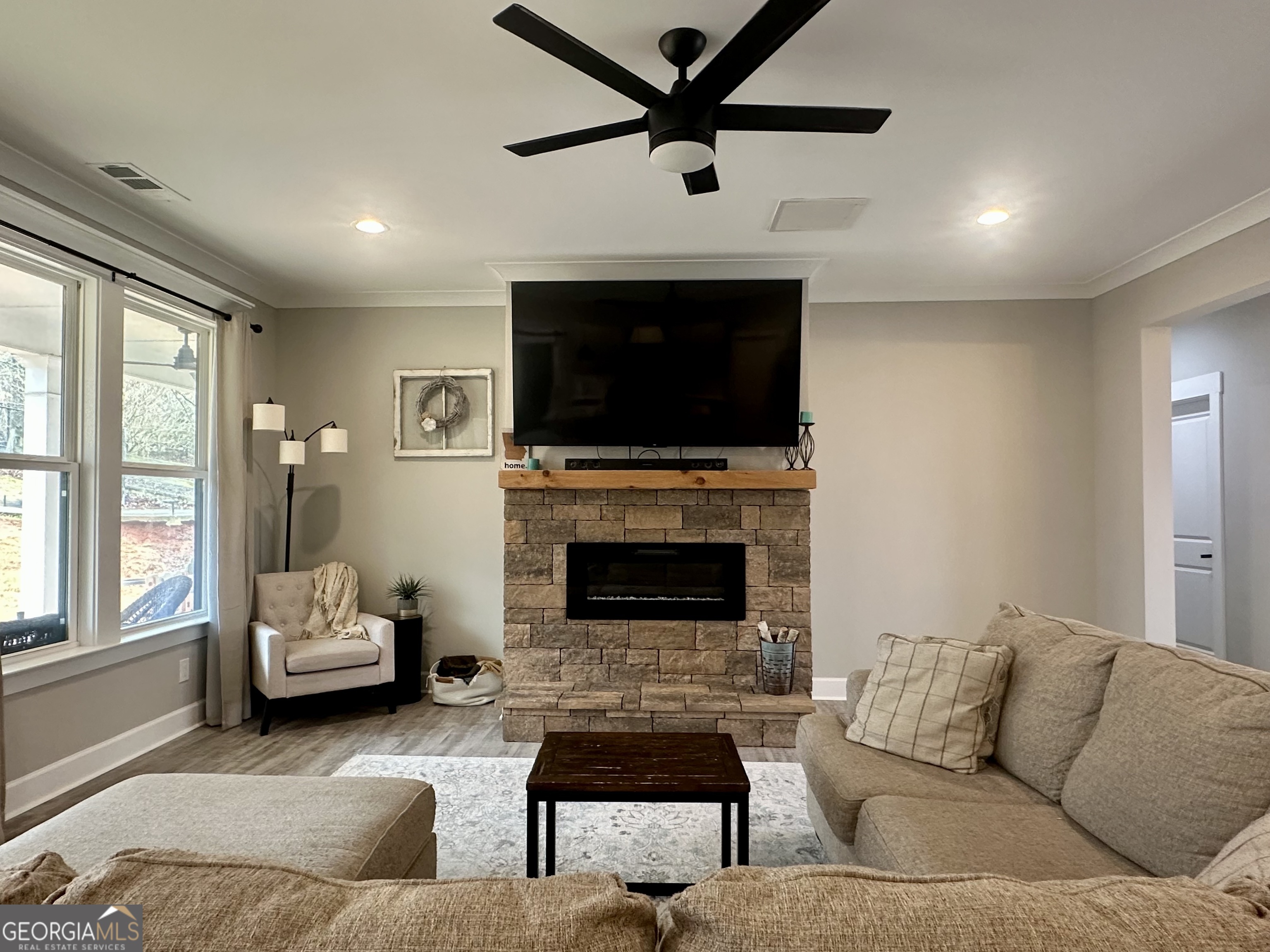 506 Summit View Drive Jefferson, GA 30549 - Photo 22 of 52 a living room with furniture a flat screen tv and a fireplace