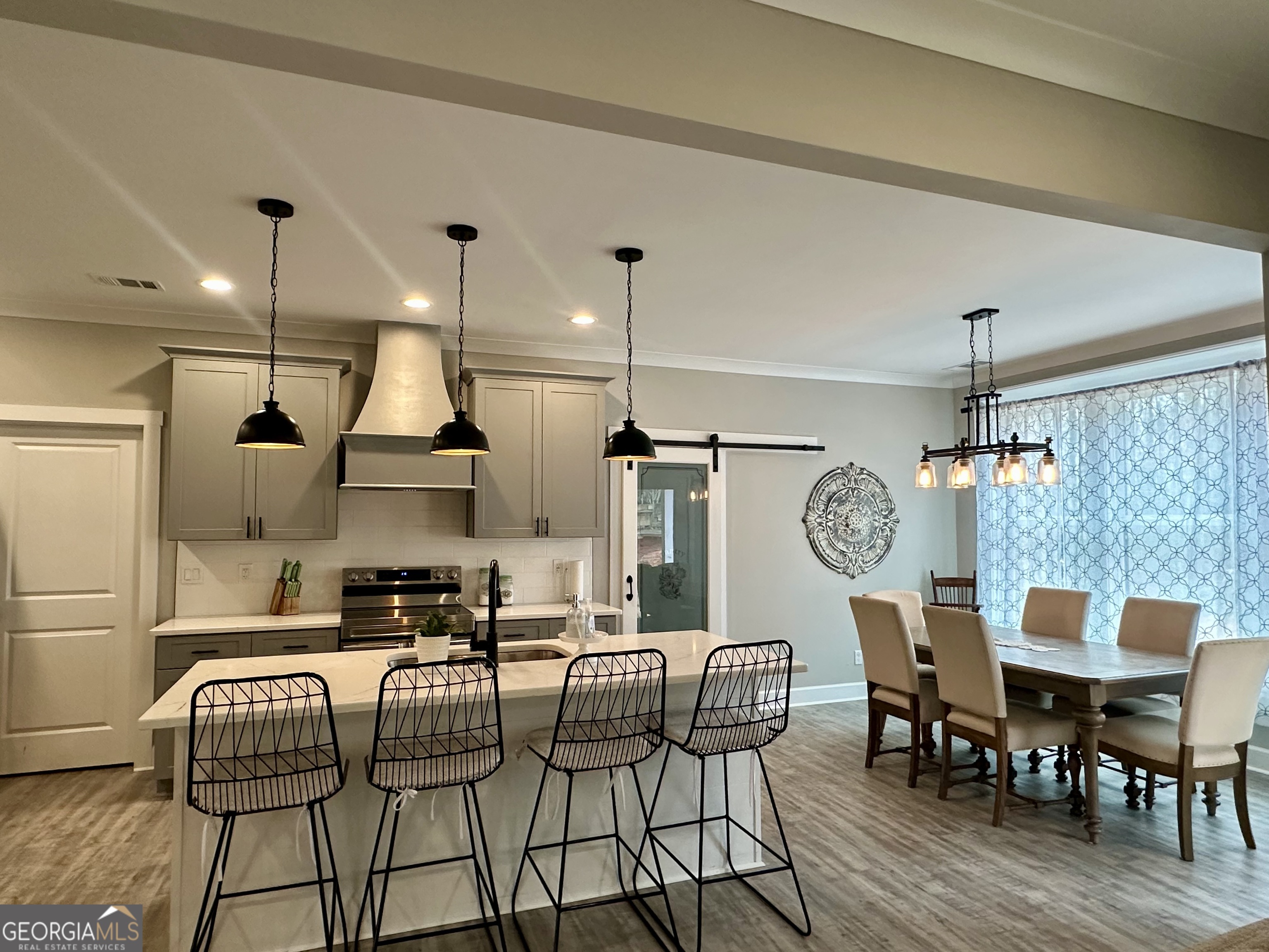 506 Summit View Drive Jefferson, GA 30549 - Photo 23 of 52 a kitchen with stainless steel appliances kitchen island granite countertop a dining table chairs and a refrigerator
