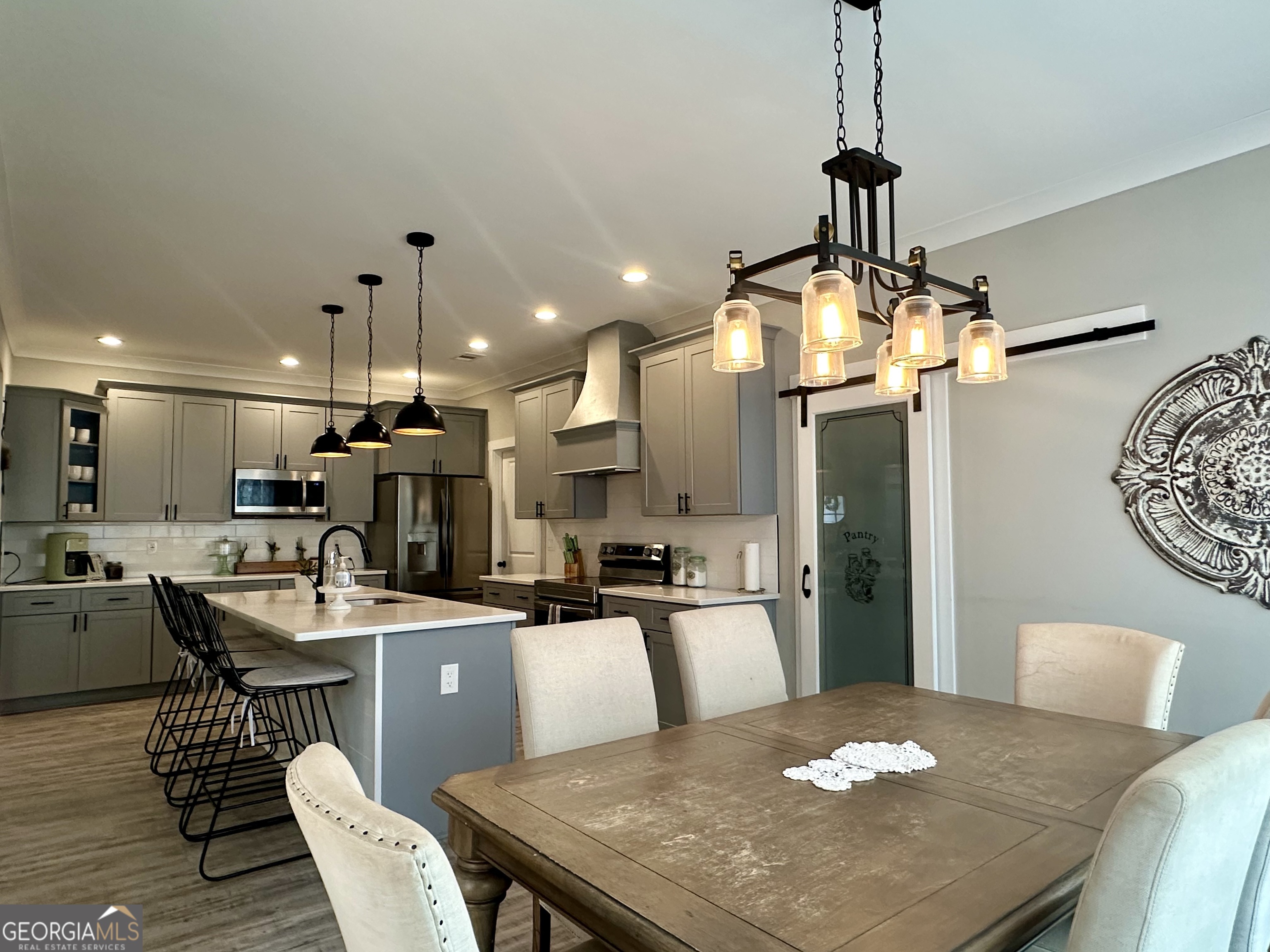 506 Summit View Drive Jefferson, GA 30549 - Photo 25 of 52 a kitchen with a dining table chairs stainless steel appliances and cabinets