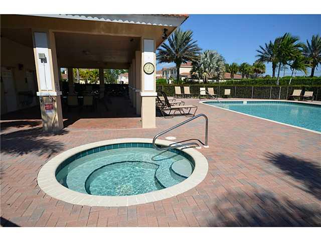 415 Southwest Walking Path Stuart, FL 34997 - Photo 14 of 16 a swimming pool with outdoor seating