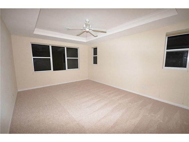 415 Southwest Walking Path Stuart, FL 34997 - Photo 7 of 16 a view of an empty room with a window and kitchen view