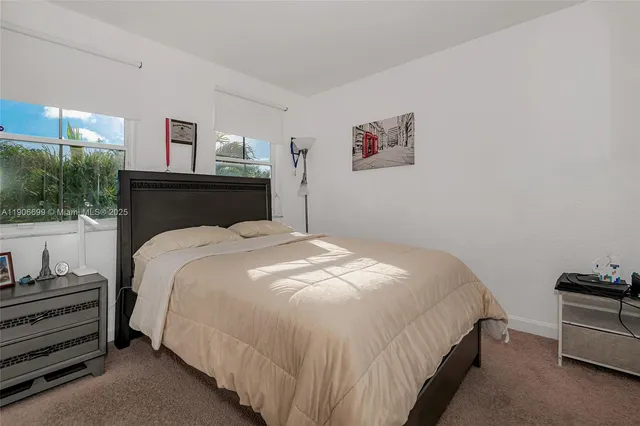 a bedroom with a bed and lamp with window
