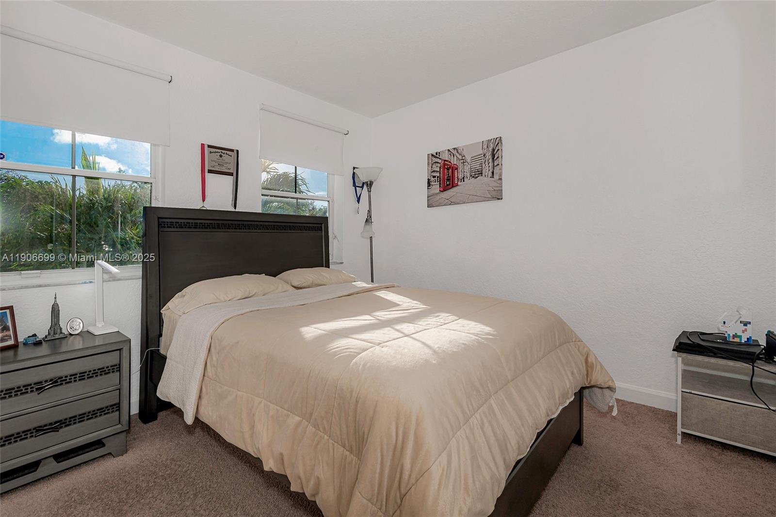 3816 Southwest 169th Terrace Miramar, FL 33027 - Photo 13 of 21 a bedroom with a bed and lamp with window