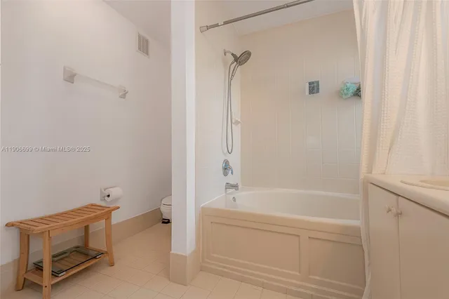 a bathroom with a bathtub and shower