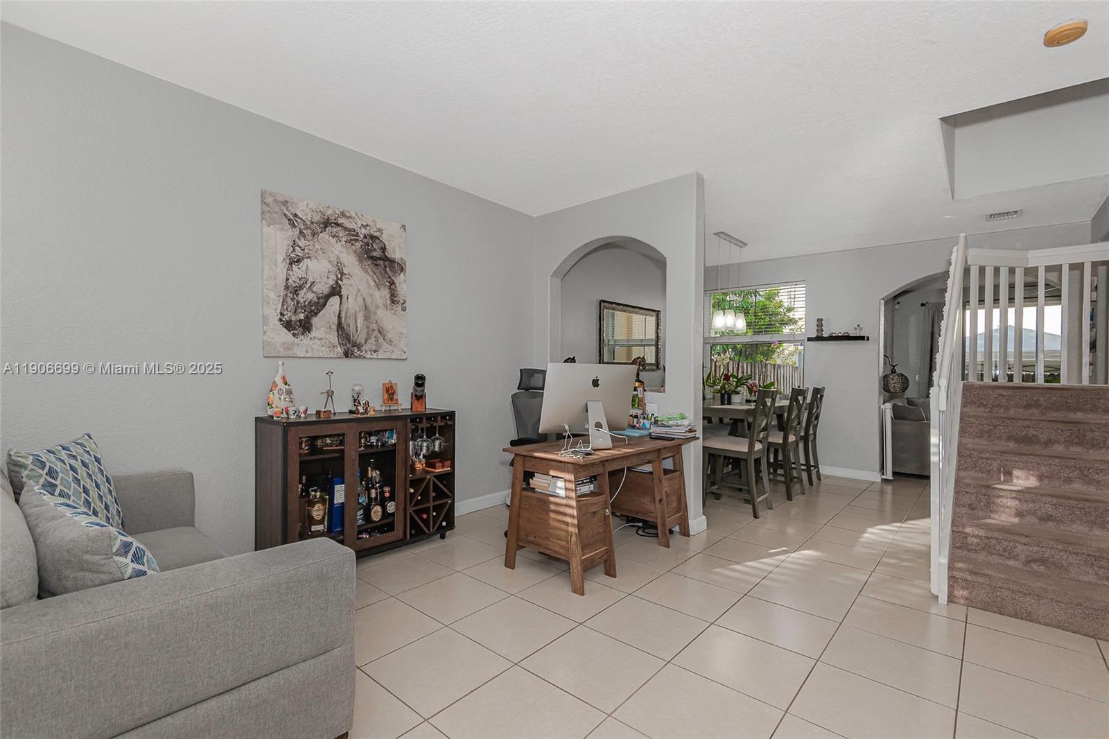 3816 Southwest 169th Terrace Miramar, FL 33027 - Photo 2 of 21 a living room with furniture and a dining table with chairs